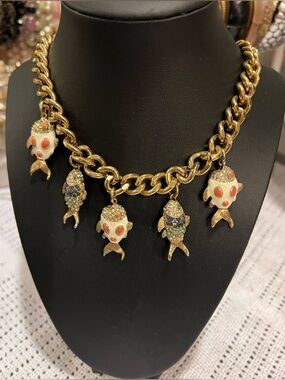 Gold-Tone Fish Charm Necklace with navy blue and Blue turquoise stone designs.